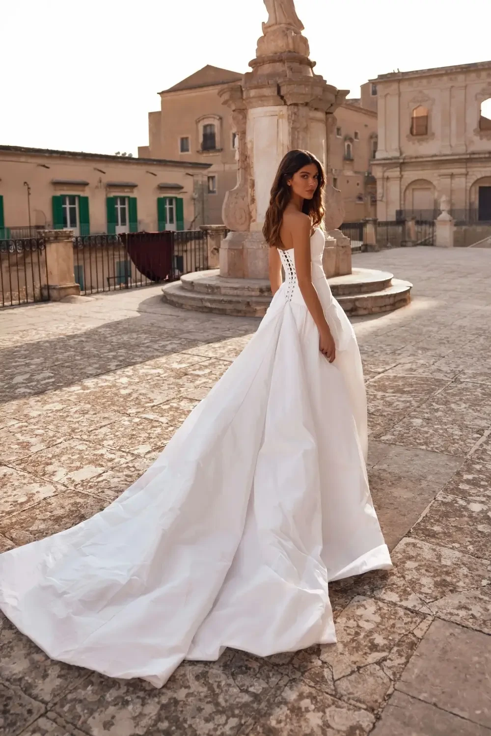 model is wearing a strapless a-line wedding dress