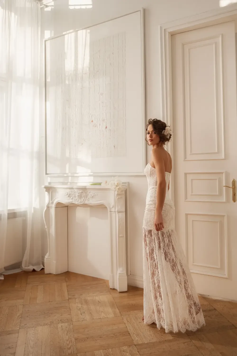 model is wearing a strapless lace bridal gown with an optional skirt