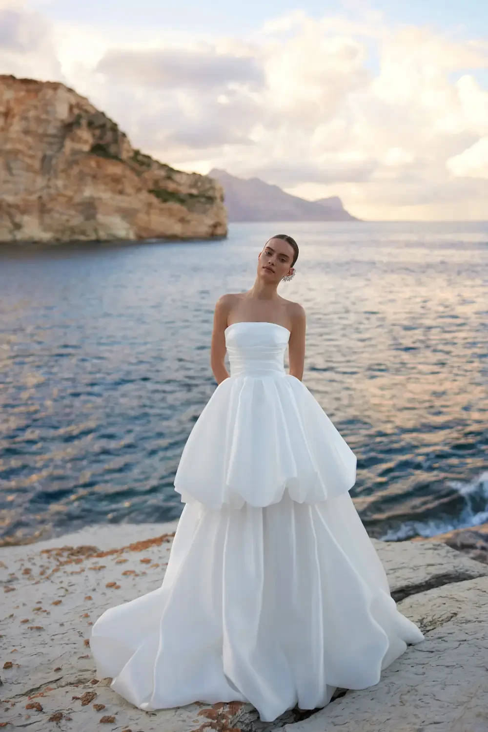 model is wearing a strapless mini bridal gown