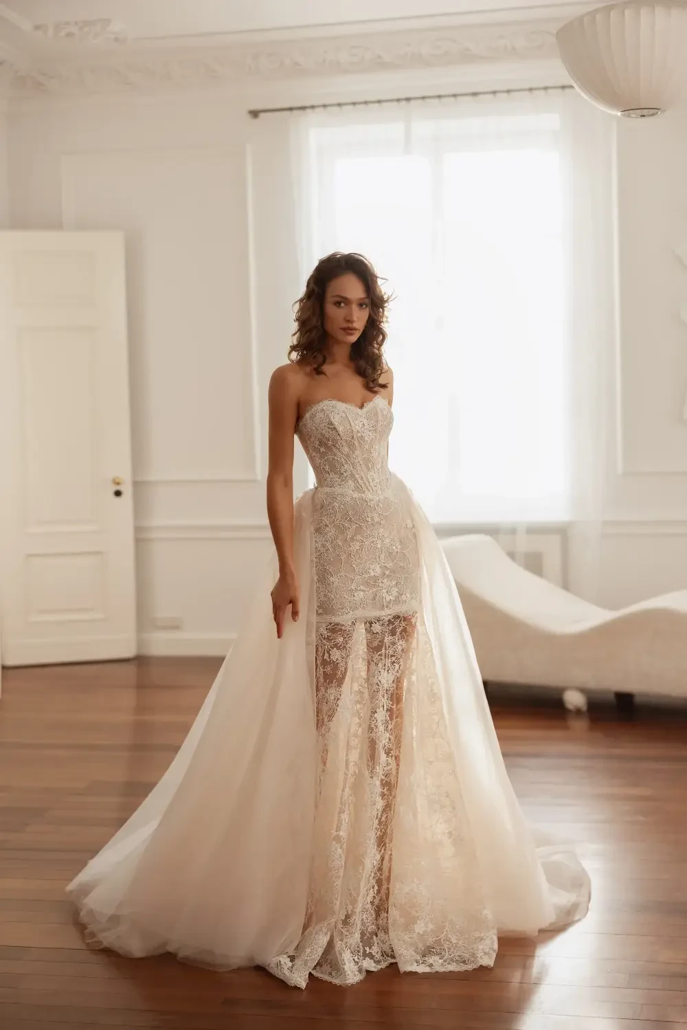 model is wearing a strapless lace bridal mini dress